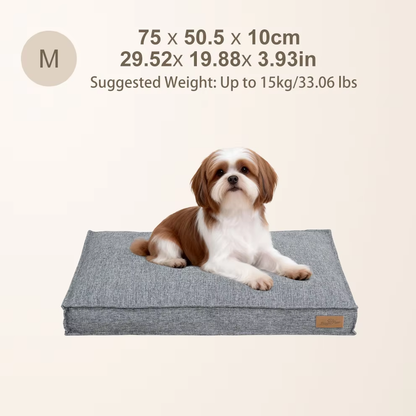 A small dog rests on a medium-sized gray rectangular dog bed, with sizing and weight details shown above.