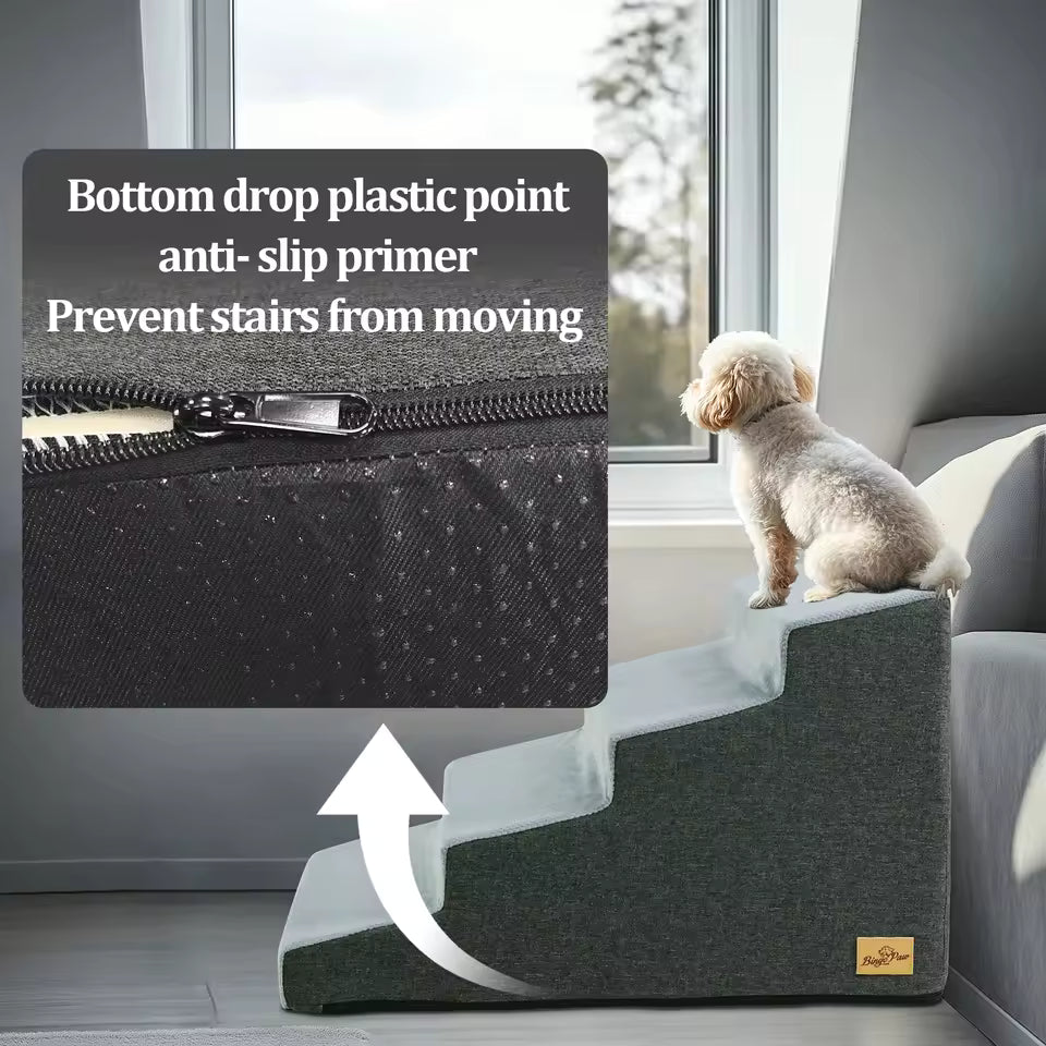 A small dog sits on a 4-step grey foam pet staircase with an anti-slip bottom.