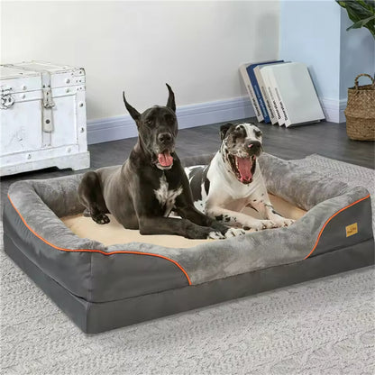 Two large Great Dane dogs resting together inside a spacious gray and tan orthopedic pet bolster couch.