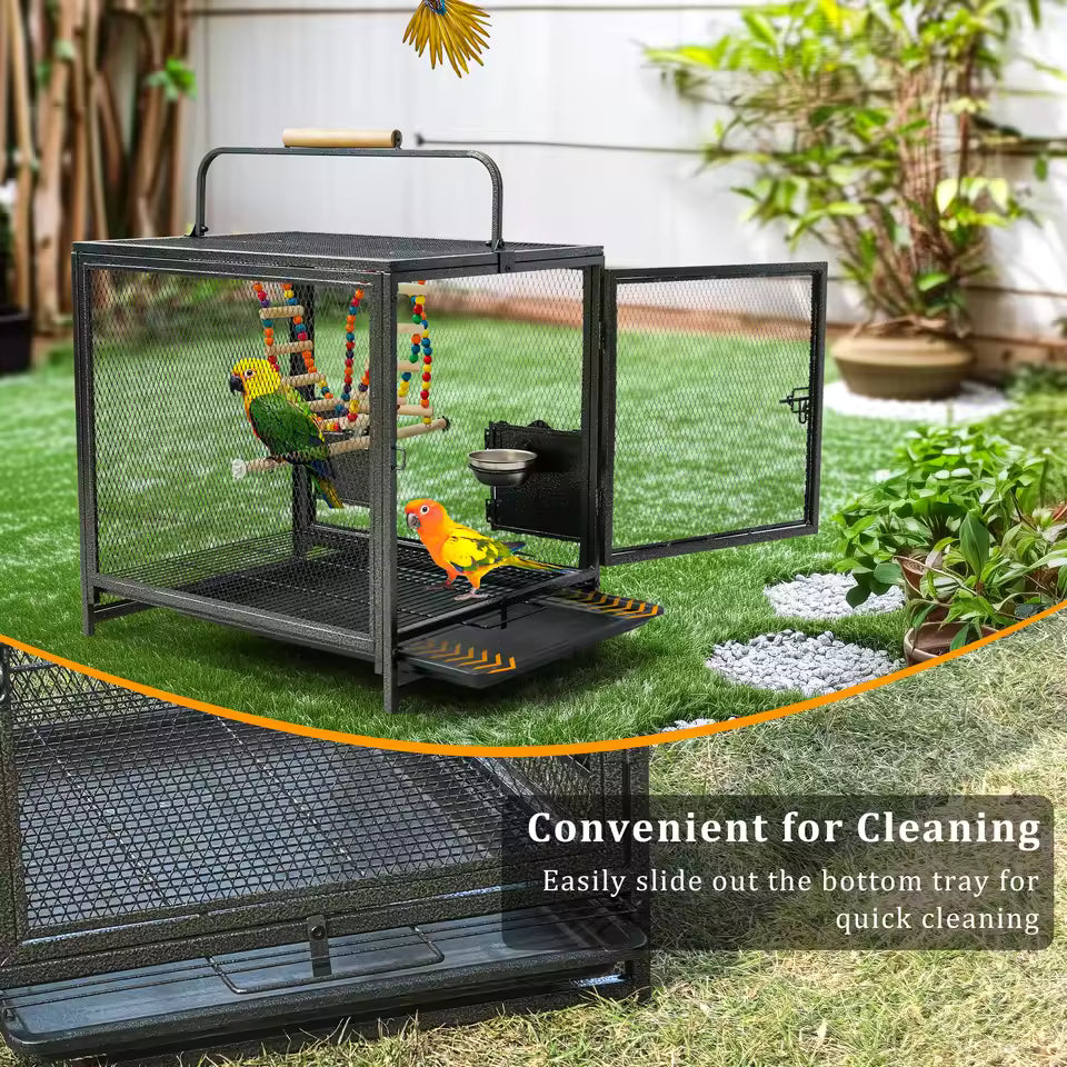 A metal bird cage on grass highlighting its convenient slide-out bottom tray for easy cleaning.