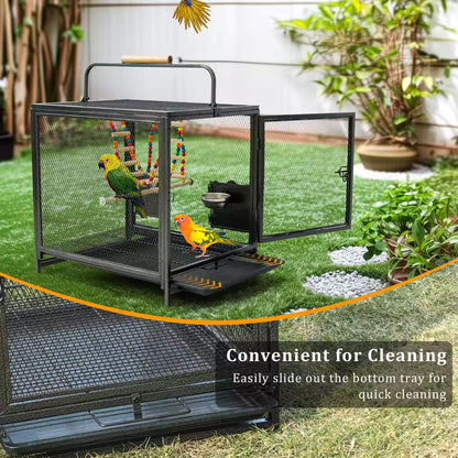 A metal bird cage on grass highlighting its convenient slide-out bottom tray for easy cleaning.