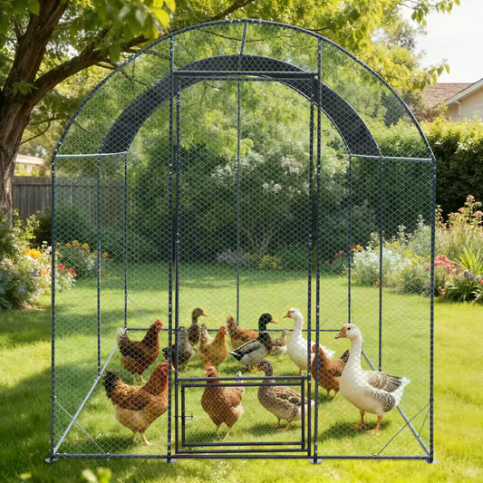 Large metal chicken coop in a lush backyard garden with multiple chickens and ducks standing inside.