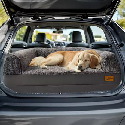 A golden retriever sleeping on a gray pet bed inside the trunk of a car.