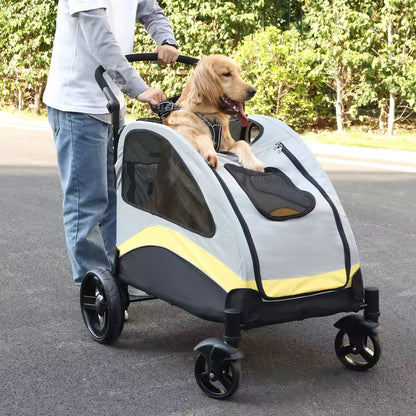 Golden Retriever sitting in a gray and yellow pet stroller with its front paws resting on the edge outdoors.